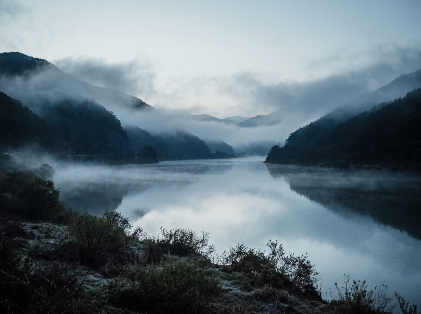 A river under low dawn mist